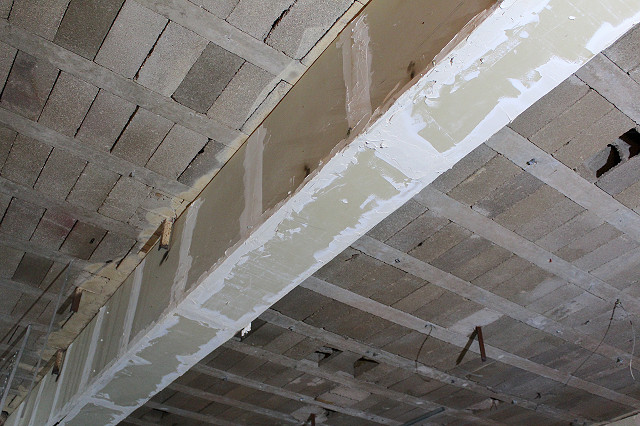 inside former nightclub asbestos debris on beams behind plasterboard