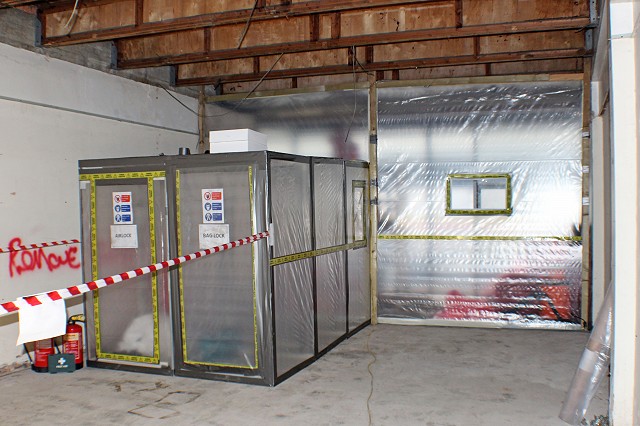 View of the asbestos enclosure inside a small shop unit with 3-stage airlock and baglocks set up
