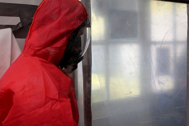 Asbestos operative entering an enclosure with full RPE and overalls